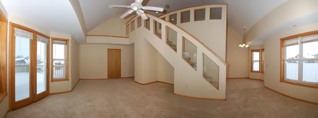 Living room with glass-paneled staircase